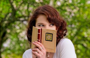 woman_hiding_behind_book